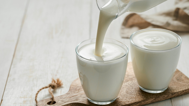 Pouring thick dairy into cup