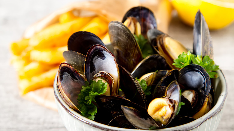 mussels in bowl with herbs