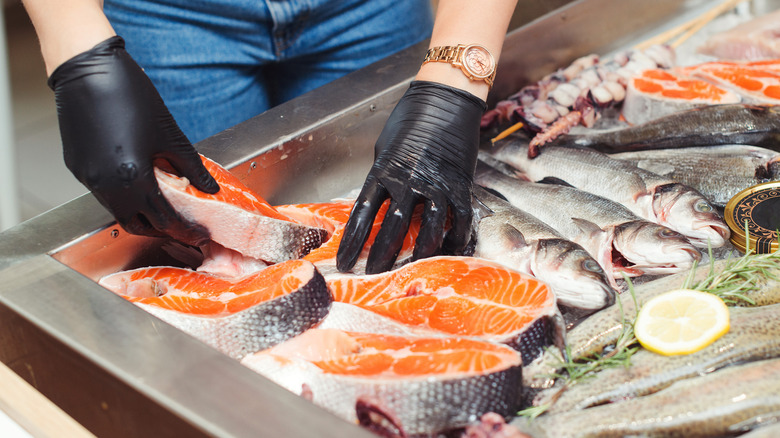 Person handling salmon filets