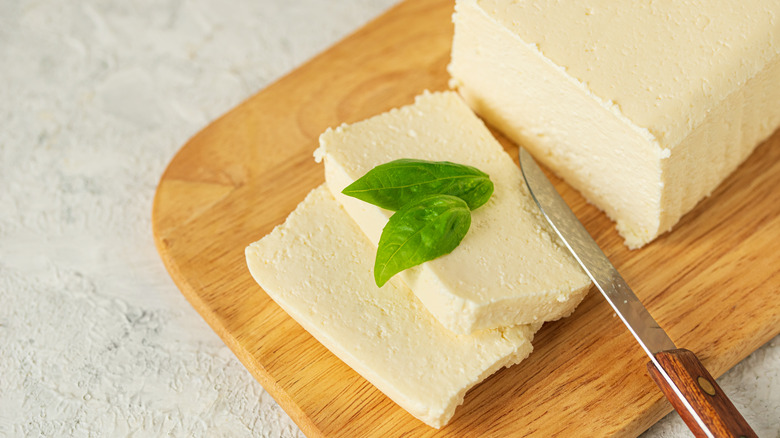 Block of fresh feta with two slices cut out 