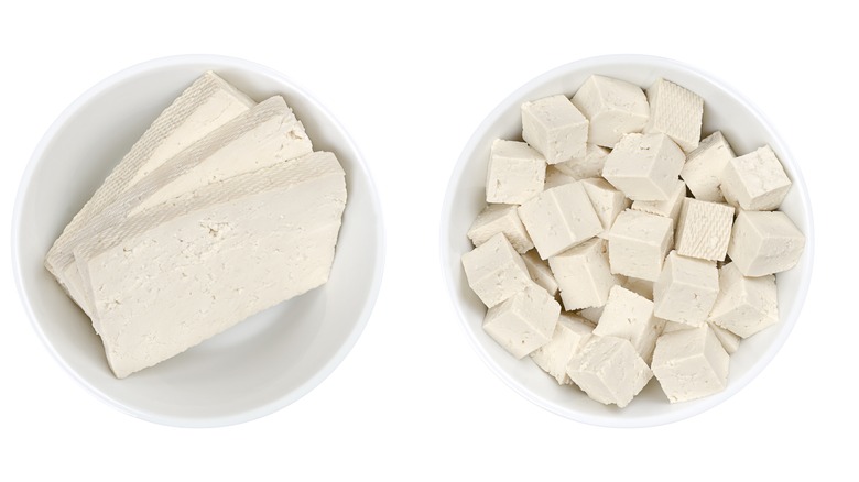 Tofu blocks in white bowls 