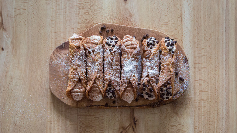 homemade cannoli on wooden board