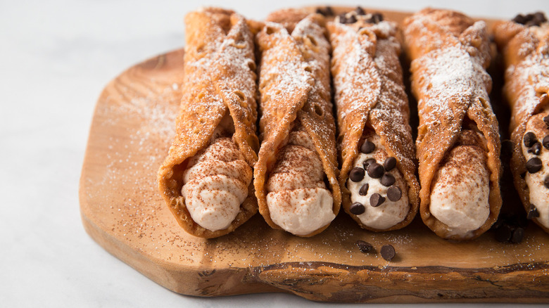 tiramisu cannoli on wooden board