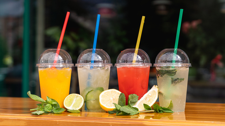 line of cocktails in plastic cups