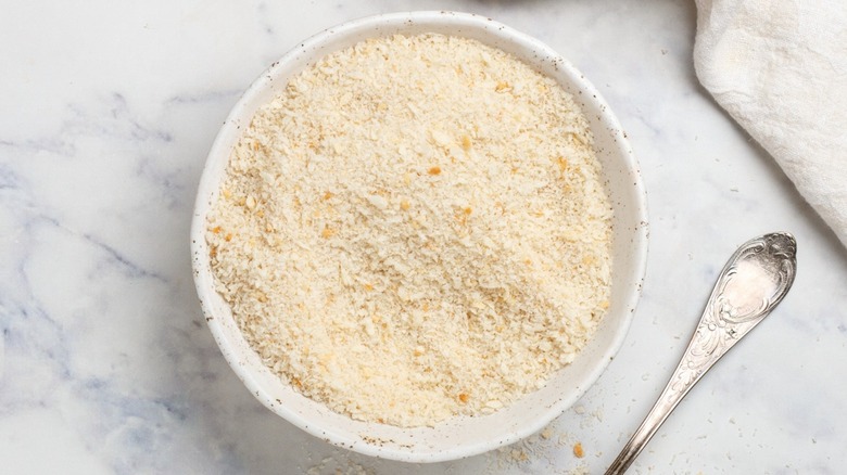 Top-down view of a bowl of panko bread crumbs on a white counter