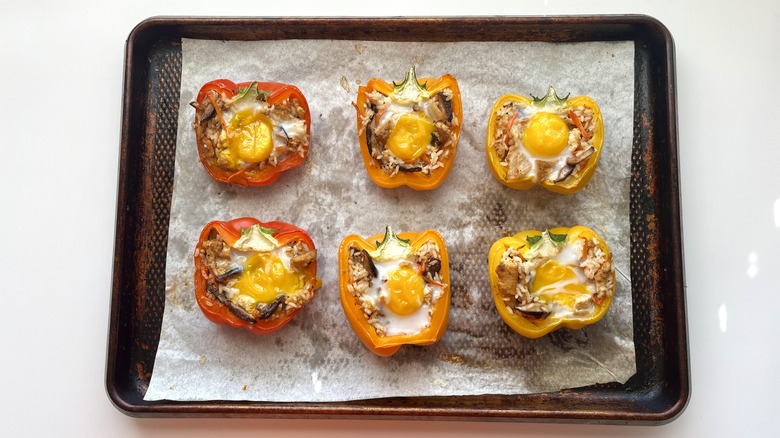 stuffed bell peppers with egg on baking sheet