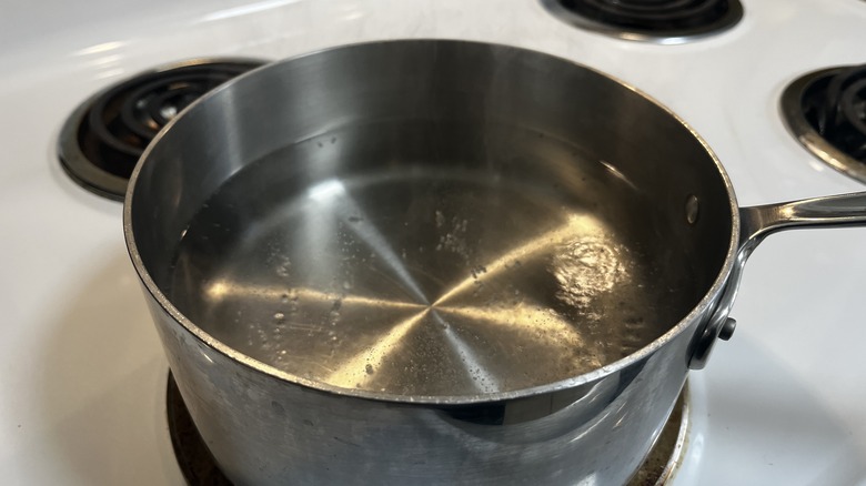 water in metal pot on stovetop