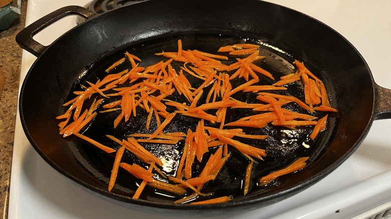 shredded carrots in frying pan