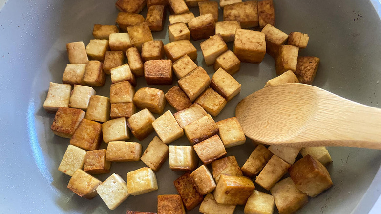 fried tofu cubes in pan