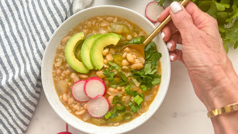 hand with spoon in bowl