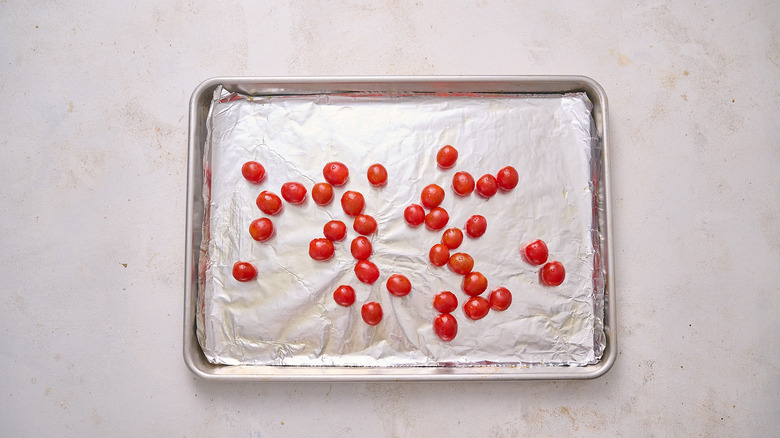 tossing cherry tomatoes in oil