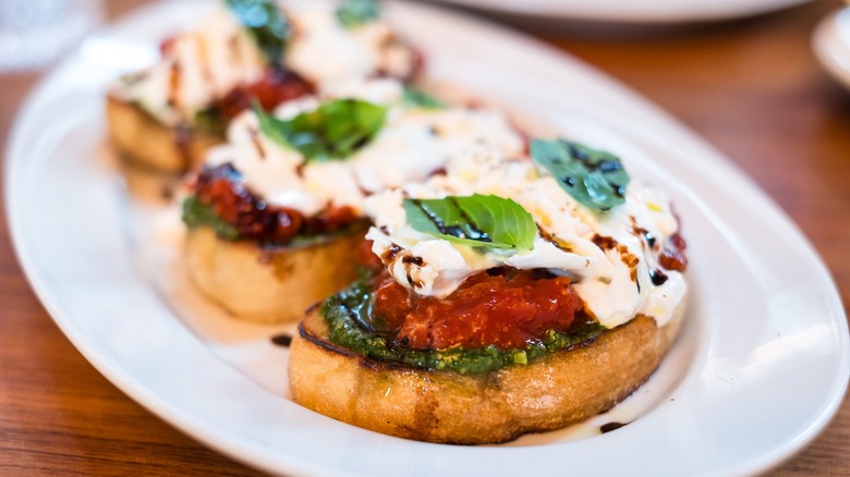 roasted tomato, cheese, and pesto bruschetta