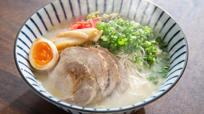 steaming bowl of tonkotsu ramen with pork and egg