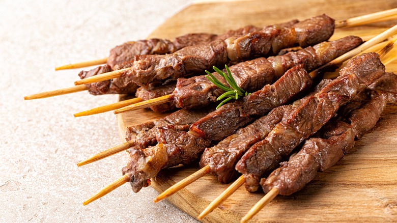 Resting lamb kebabs on table