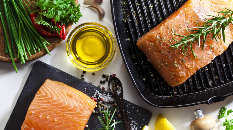 Fresh salmon steaks with herbs, salt, pepper, and olive oil