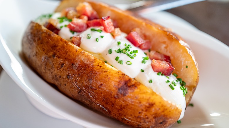 A potato with sour cream and bacon.