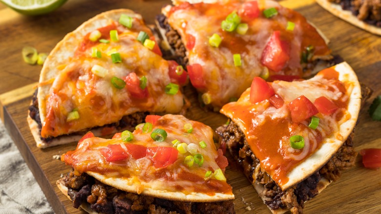 quesadilla pizza cut into fourths on cutting board