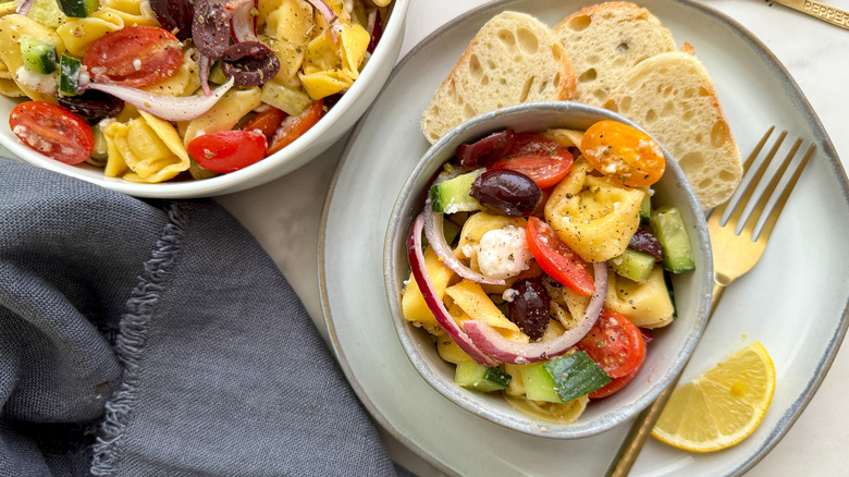 bowl of salad with slices of bread and gold fork