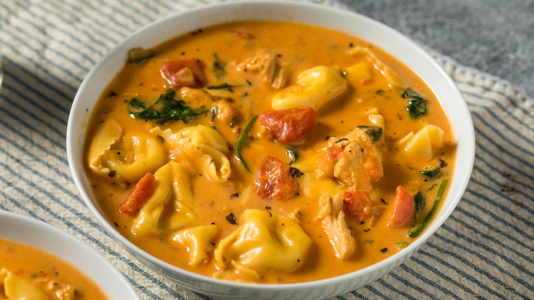 Creamy tortellini soup with spinach and tomatoes