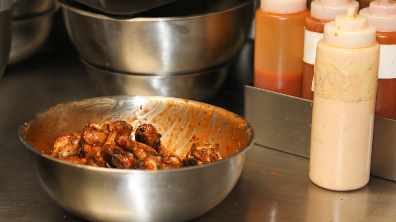 bowl of chicken wings with sauces