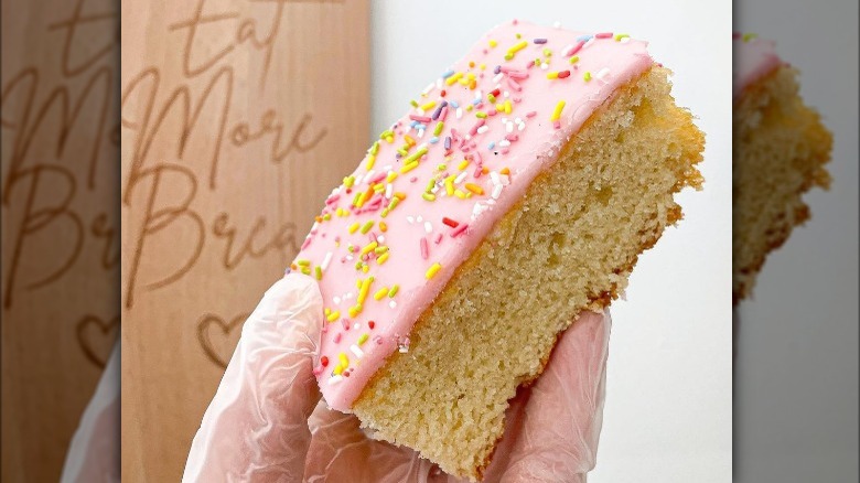 Piece of Tottenham cake held in the air