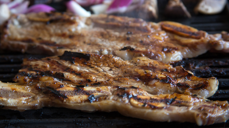 Korean beef short ribs cooking on a grill