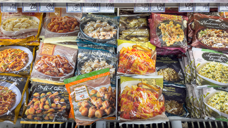 Bags of different frozen entrees in a Trader Joe's freezer case