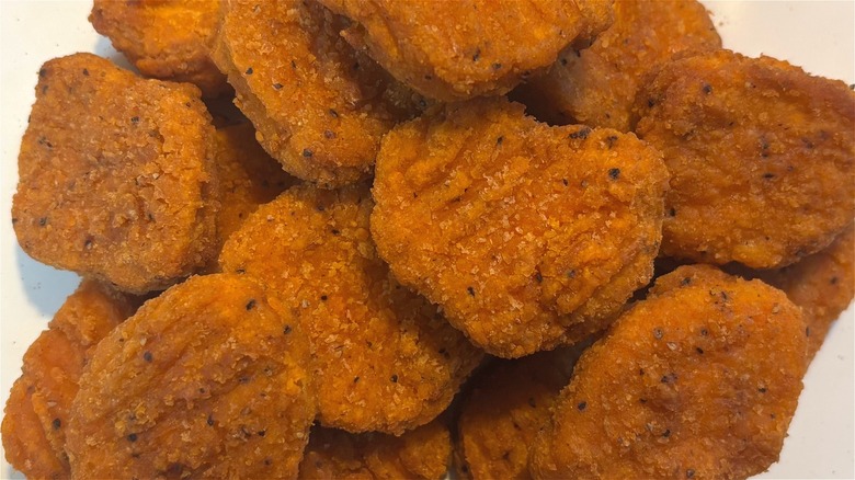 A pile of Trader Joe's Spicy Chicken Nuggets on white plate