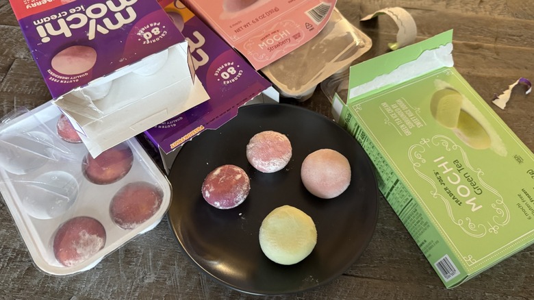 Boxes of mochi ice cream opened with a plate of mochi ice creams