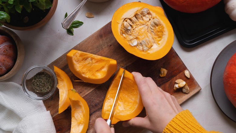 Hand slicing orange squash