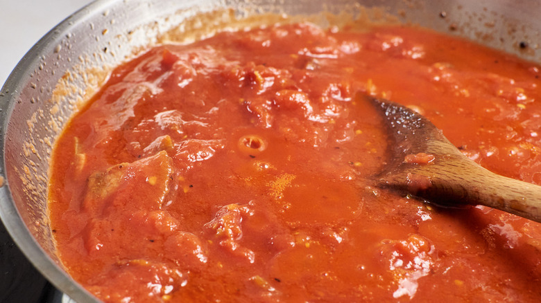 simmering tomatoes in skillet