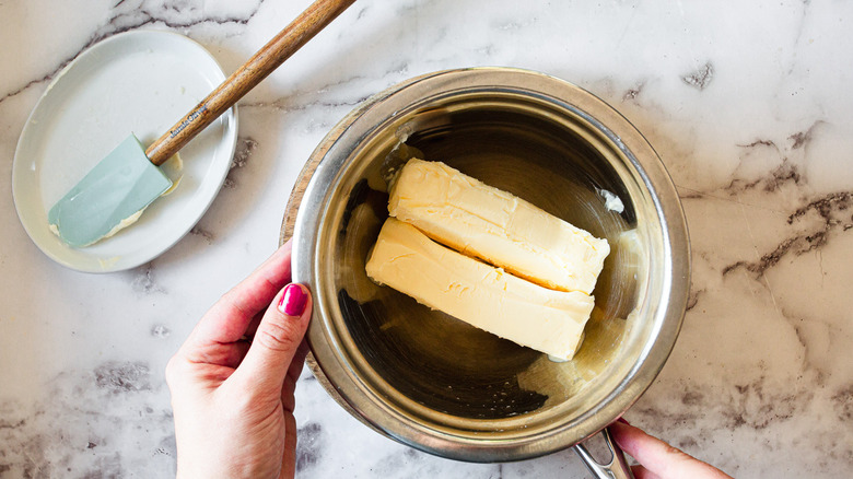 metal bowl with two sticks of butter