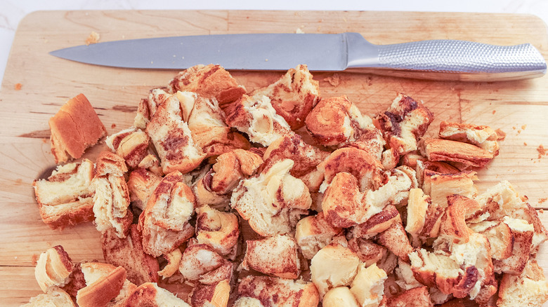 Diced cinnamon rolls on cutting board 