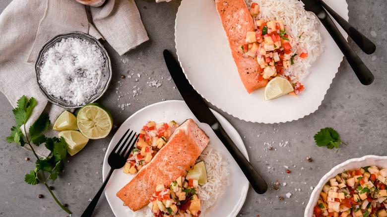 plates of grilled salmon with rice and salsa