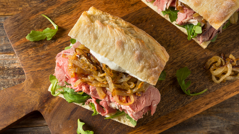 Prime rib sandwich with grilled onion and arugula 