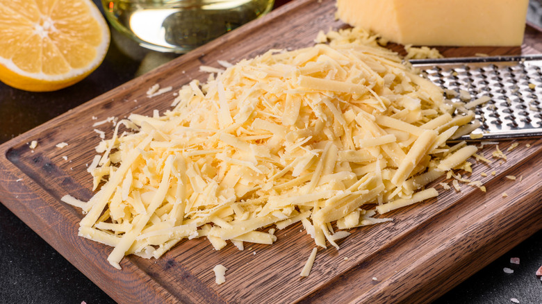 Freshly grated cheese on a chopping board