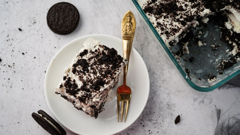 oreo icebox cake on a plate with a gold fork
