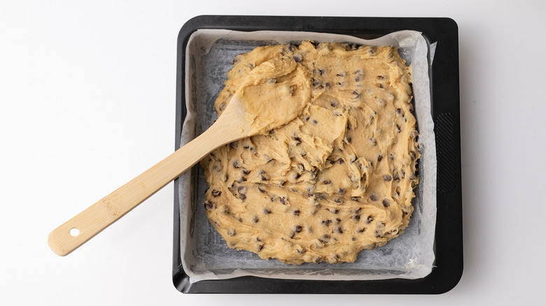 spreading cookie dough in pan