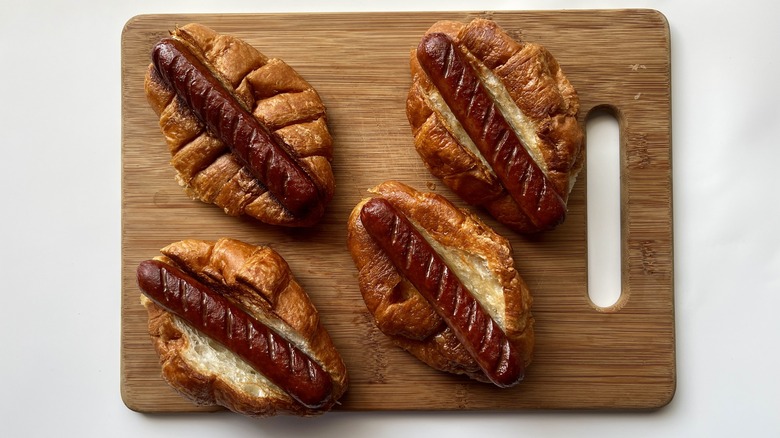 croissant hot dogs on cutting board