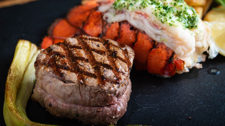 surf and turf on black stone plate