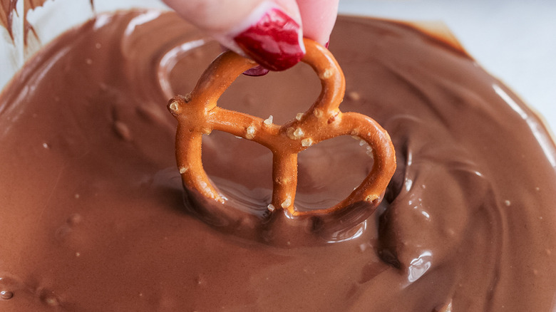 dipping pretzels in chocolate caramel