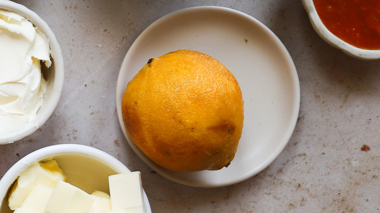 Single bergamot citrus on plate