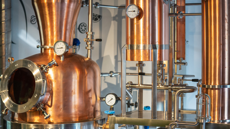 Close-up of copper still and equipment at a small craft distillery