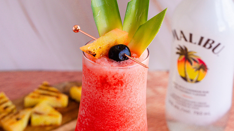 Close up on garnish with alcohol in background