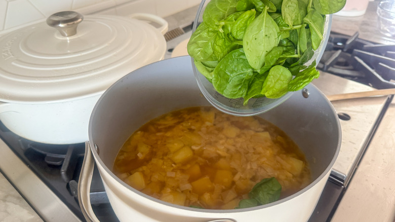 Spinach going into soup pot