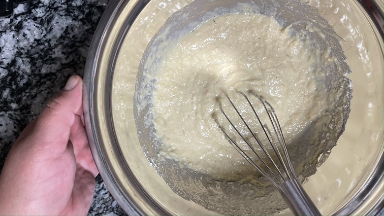 whisking pancake batter in bowl