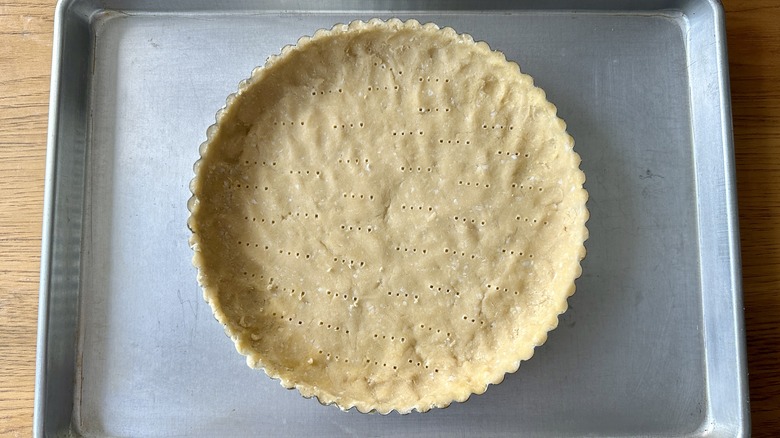 Pricked tart shell in pan