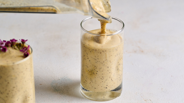 pouring smoothie into glass