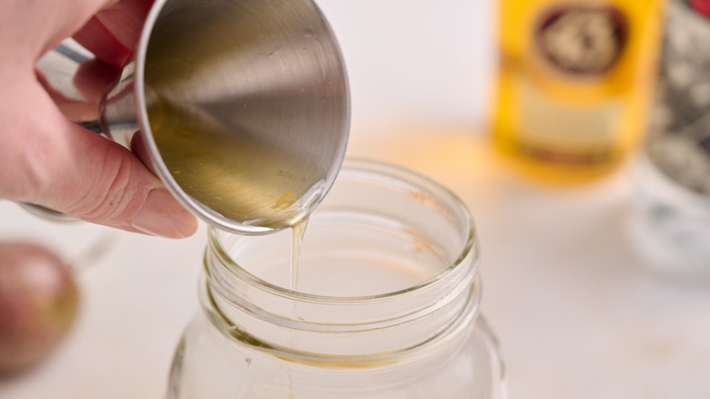 pouring liquor into cocktail shaker