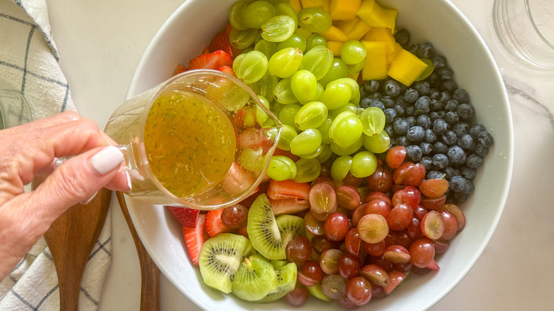 Pouring dressing on fruits